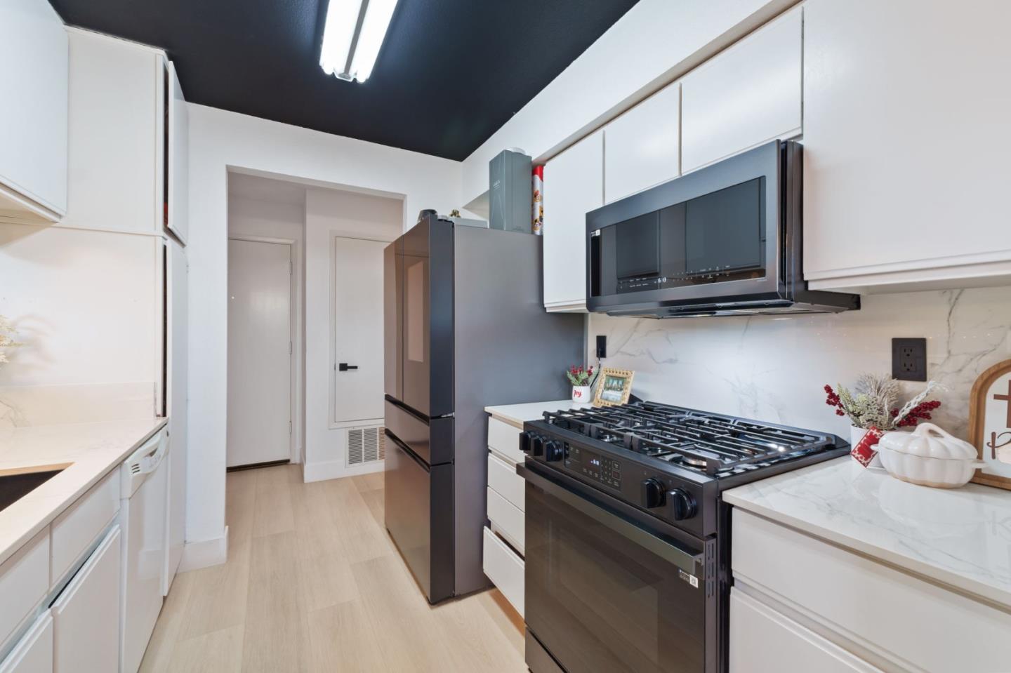 2422 North Main Street, Unit F Salinas, CA 93906 - Photo 11 of 22 a kitchen with stainless steel appliances granite countertop a stove microwave and refrigerator