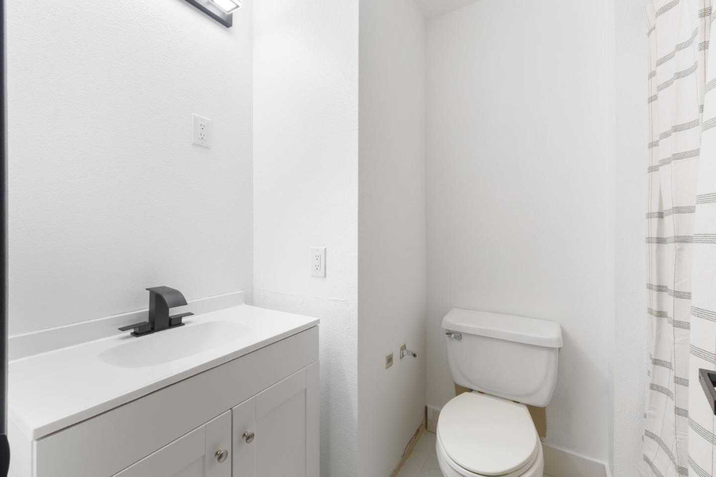 2422 North Main Street, Unit F Salinas, CA 93906 - Photo 17 of 22 a bathroom with a sink a toilet and a shower
