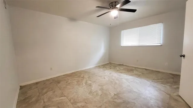 a view of empty room with ceiling fan