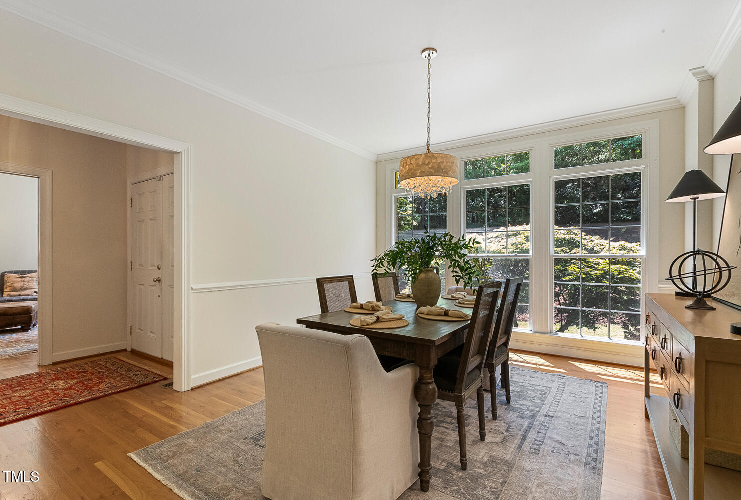 101 Cardiff Place Chapel Hill, NC 27516 - Photo 16 of 82 a dining room with furniture and floor to ceiling windows