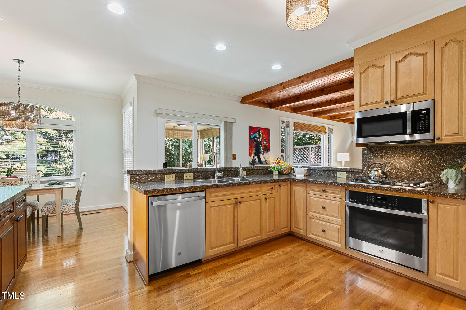 101 Cardiff Place Chapel Hill, NC 27516 - Photo 21 of 82 a kitchen with stainless steel appliances granite countertop a stove and a wooden floors