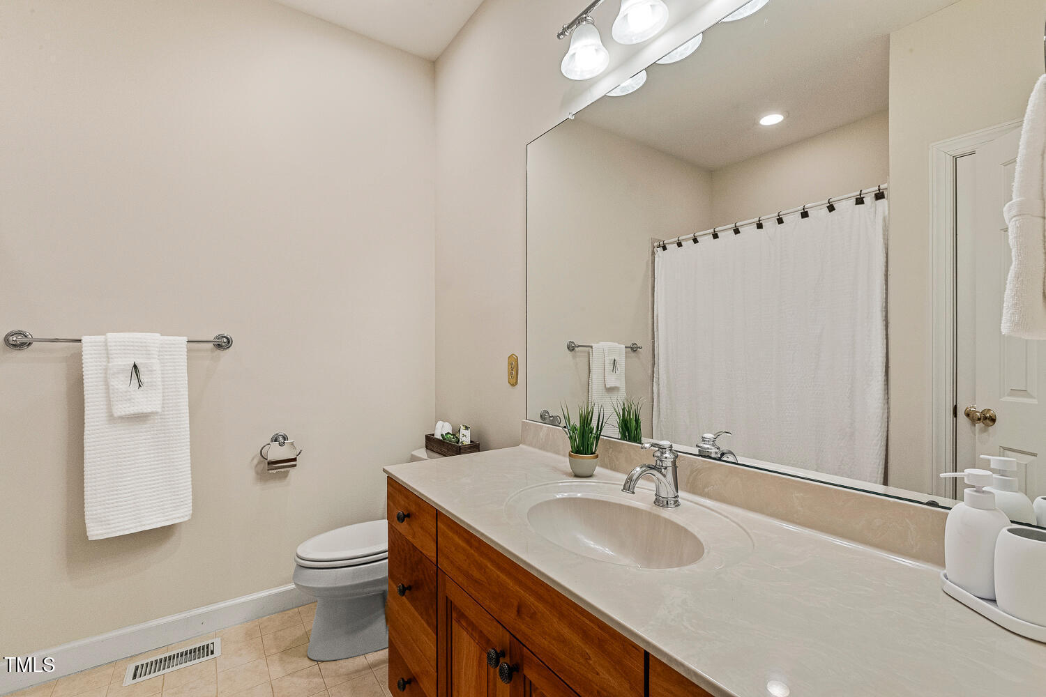 101 Cardiff Place Chapel Hill, NC 27516 - Photo 66 of 82 a bathroom with a granite countertop sink and a mirror