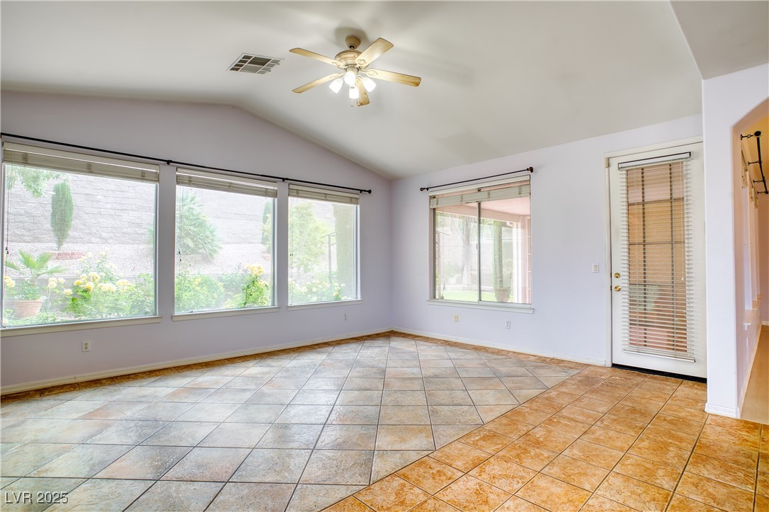 2383 Rainswept Avenue Henderson, NV 89052 - Photo 13 of 62 Unfurnished room with ceiling fan, lofted ceiling, and light tile patterned floors