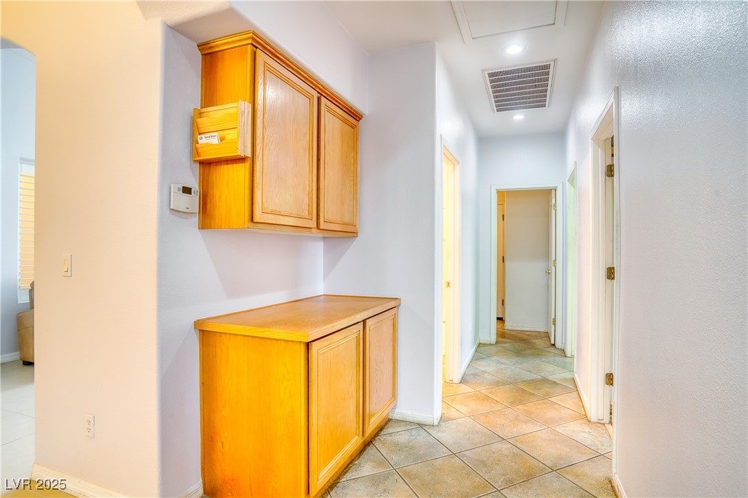 2383 Rainswept Avenue Henderson, NV 89052 - Photo 21 of 62 Hallway with light tile patterned flooring and baseboards
