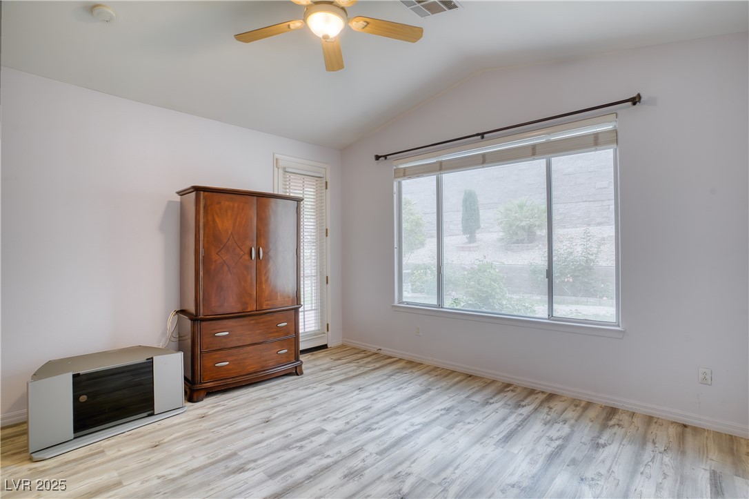 2383 Rainswept Avenue Henderson, NV 89052 - Photo 23 of 62 Unfurnished bedroom featuring vaulted ceiling, a ceiling fan, and light wood-style floors