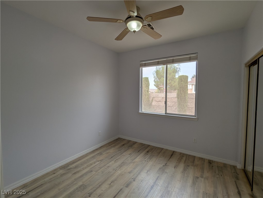 2383 Rainswept Avenue Henderson, NV 89052 - Photo 30 of 62 Unfurnished bedroom featuring a closet, light wood-type flooring, and ceiling fan, recently updated