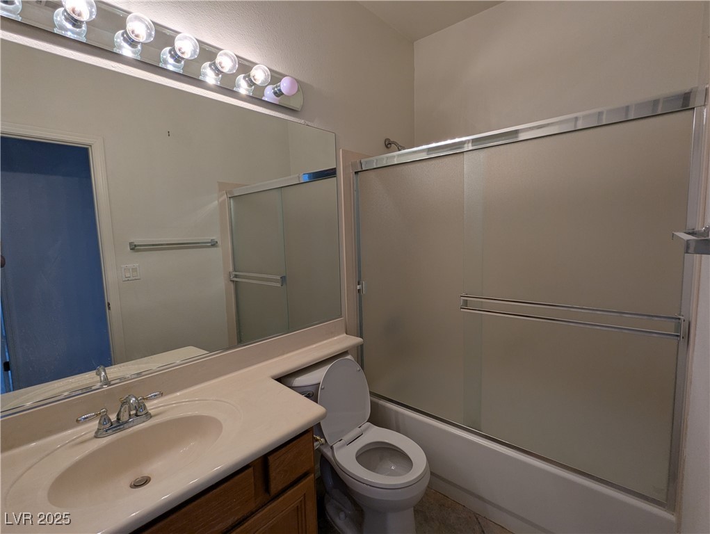 2383 Rainswept Avenue Henderson, NV 89052 - Photo 32 of 62 Bathroom featuring bath / shower combo with glass door, vanity, and tile patterned floors