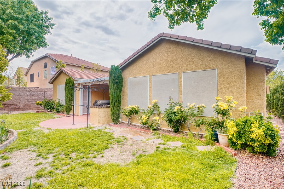 2383 Rainswept Avenue Henderson, NV 89052 - Photo 40 of 62 Back of house with stucco siding and a tiled roof