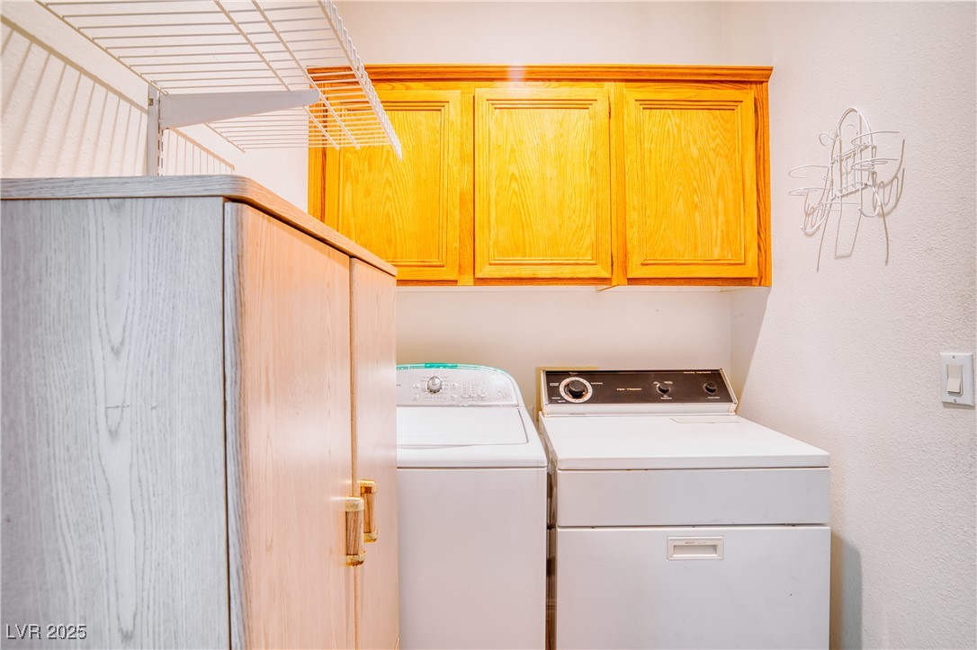 2383 Rainswept Avenue Henderson, NV 89052 - Photo 42 of 62 Laundry room featuring washer and dryer and cabinet space