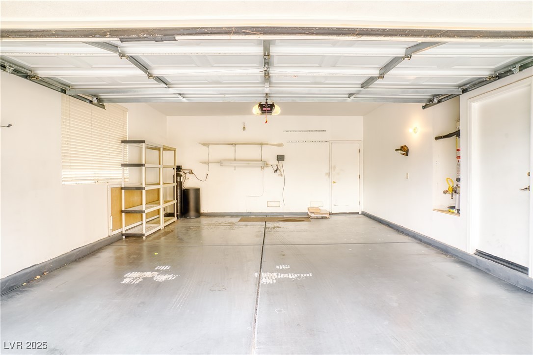 2383 Rainswept Avenue Henderson, NV 89052 - Photo 44 of 62 Garage with a garage door opener and baseboards