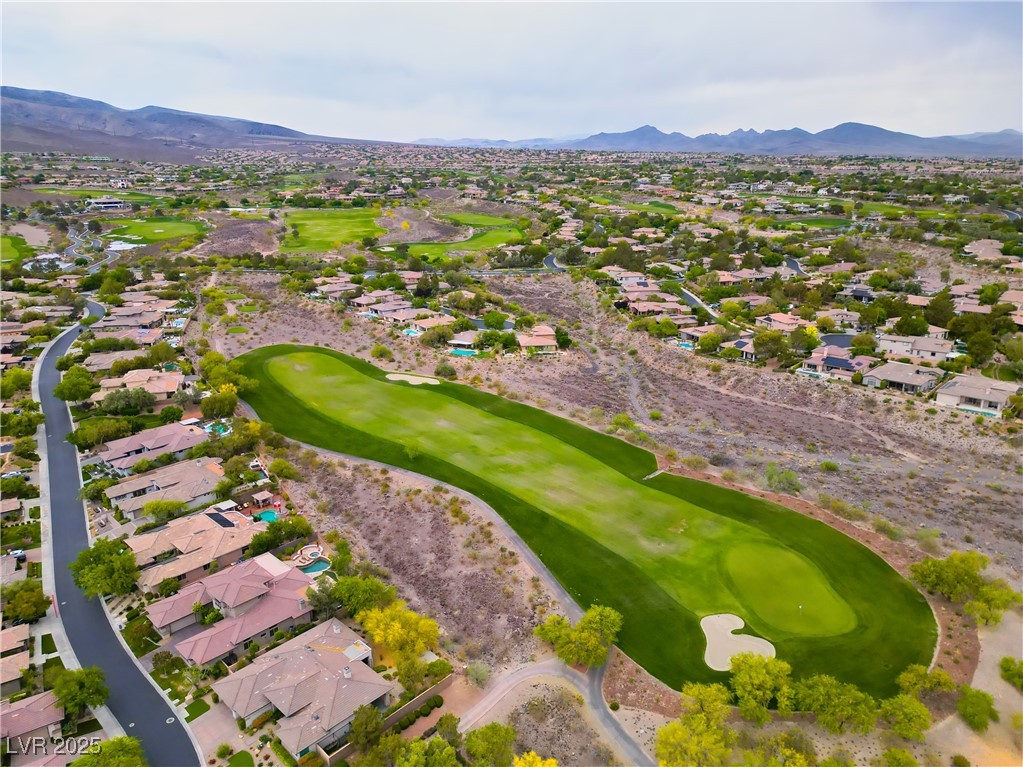 2383 Rainswept Avenue Henderson, NV 89052 - Photo 60 of 62 Aerial view of property and surrounding area with a golf course, nearby suburban area, and a mountainous background