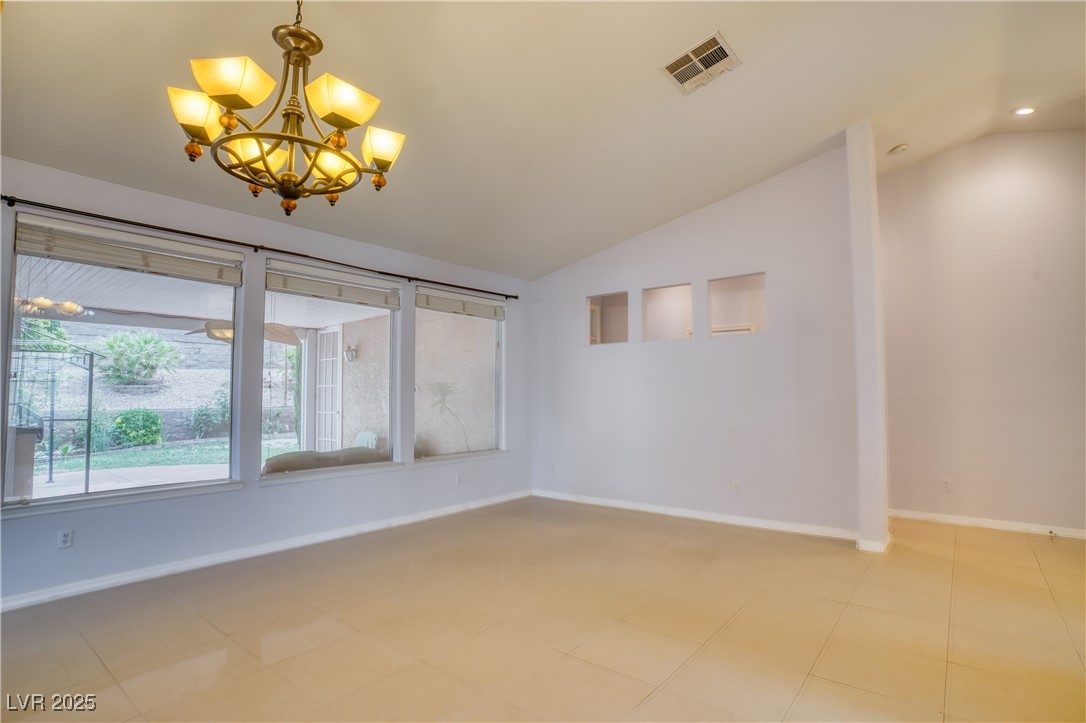 2383 Rainswept Avenue Henderson, NV 89052 - Photo 7 of 62 Unfurnished room with lofted ceiling and a chandelier