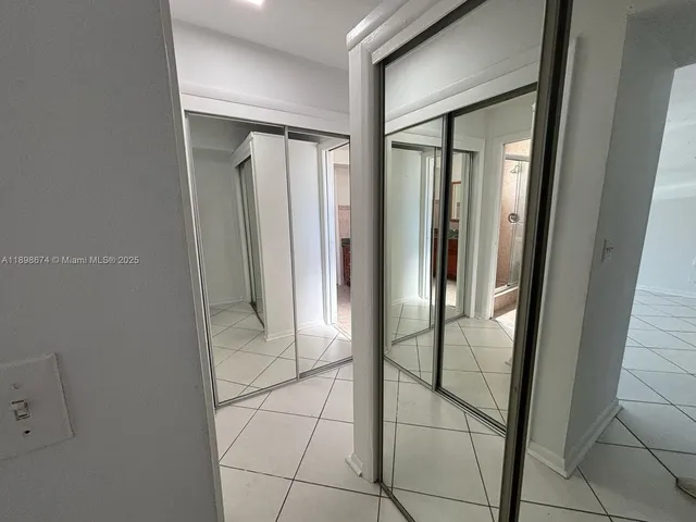 a bathroom with a shower and a glass door