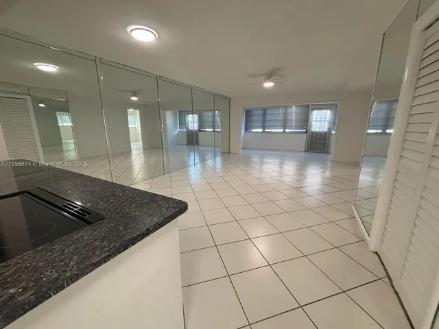 a kitchen with a sink a refrigerator and cabinets