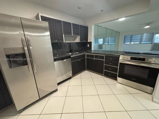 a kitchen with stainless steel appliances granite countertop a stove and a microwave