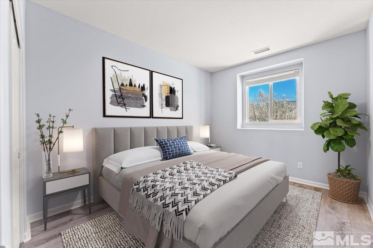 11215 Torino Way Reno, NV 89521 - Photo 16 of 21 a bedroom with a large bed and a potted plant