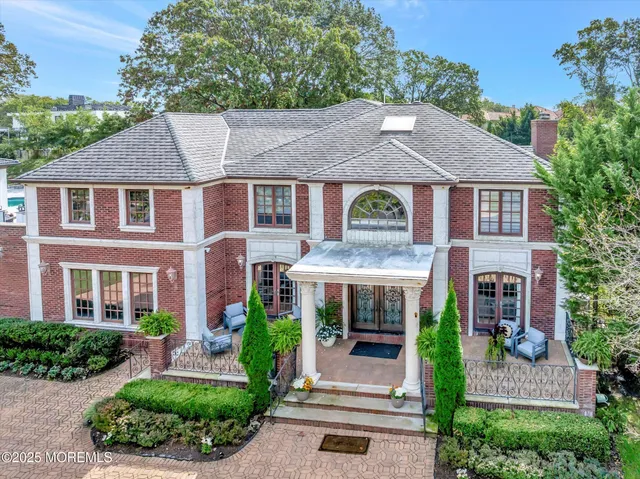 an aerial view of a house with a garden and swimming pool