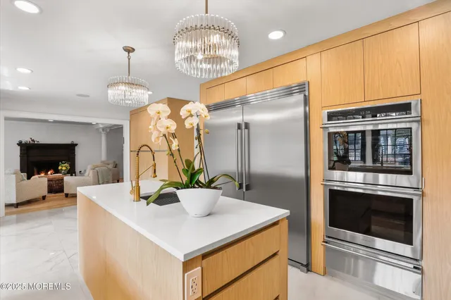 a living room with furniture kitchen view and a flat screen tv