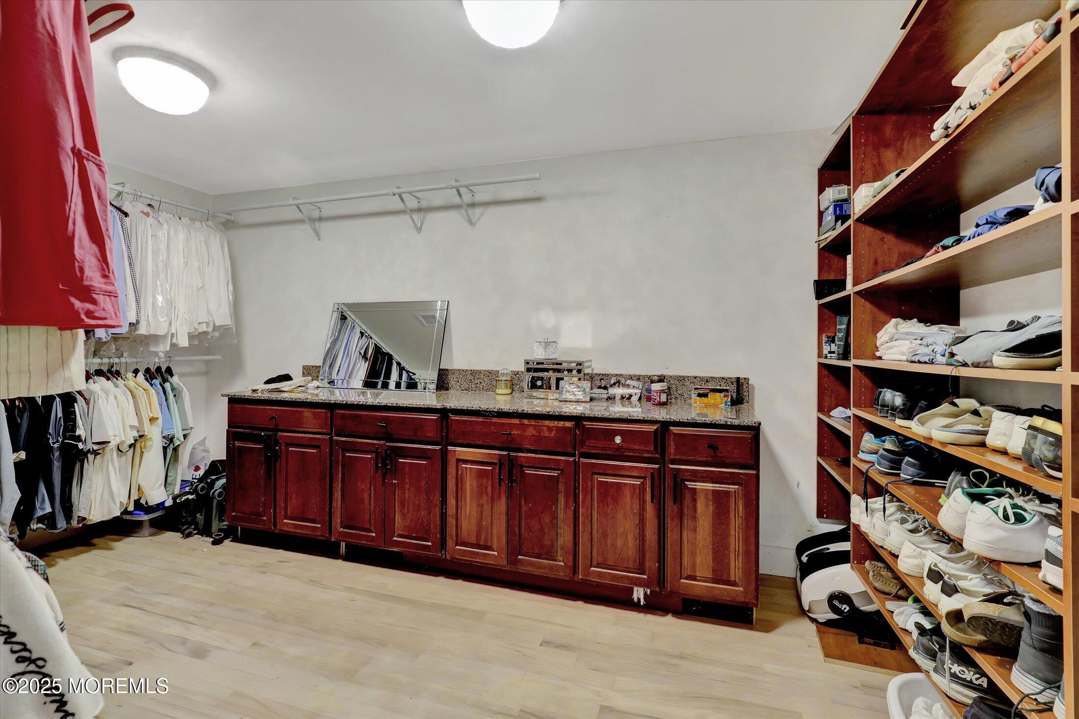 13 Valley Forge Road Eatontown, NJ 07724 - Photo 43 of 74 a view of walk in closet with clothes and shoes