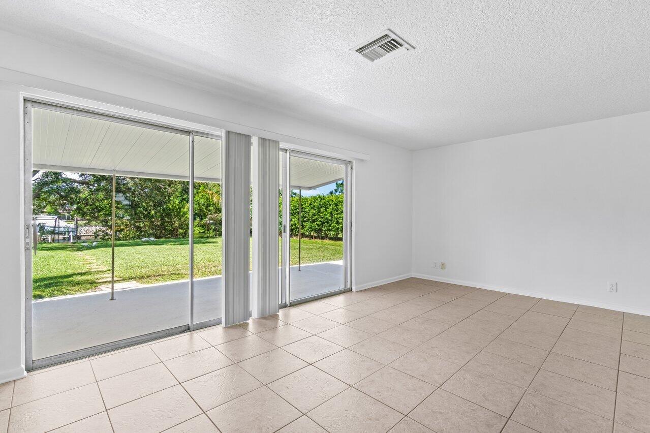 751 Hummingbird Way, Unit 7 North Palm Beach, FL 33408 - Photo 21 of 39 a view of an empty room with a large window