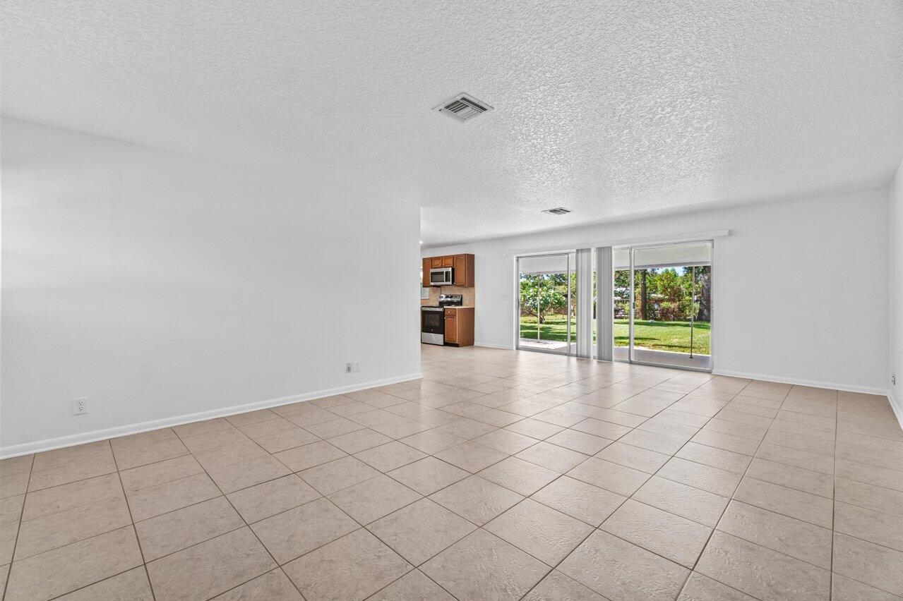 751 Hummingbird Way, Unit 7 North Palm Beach, FL 33408 - Photo 22 of 39 a view of an empty room with a window