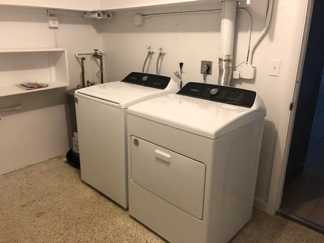 a view of storage and utility room with closet