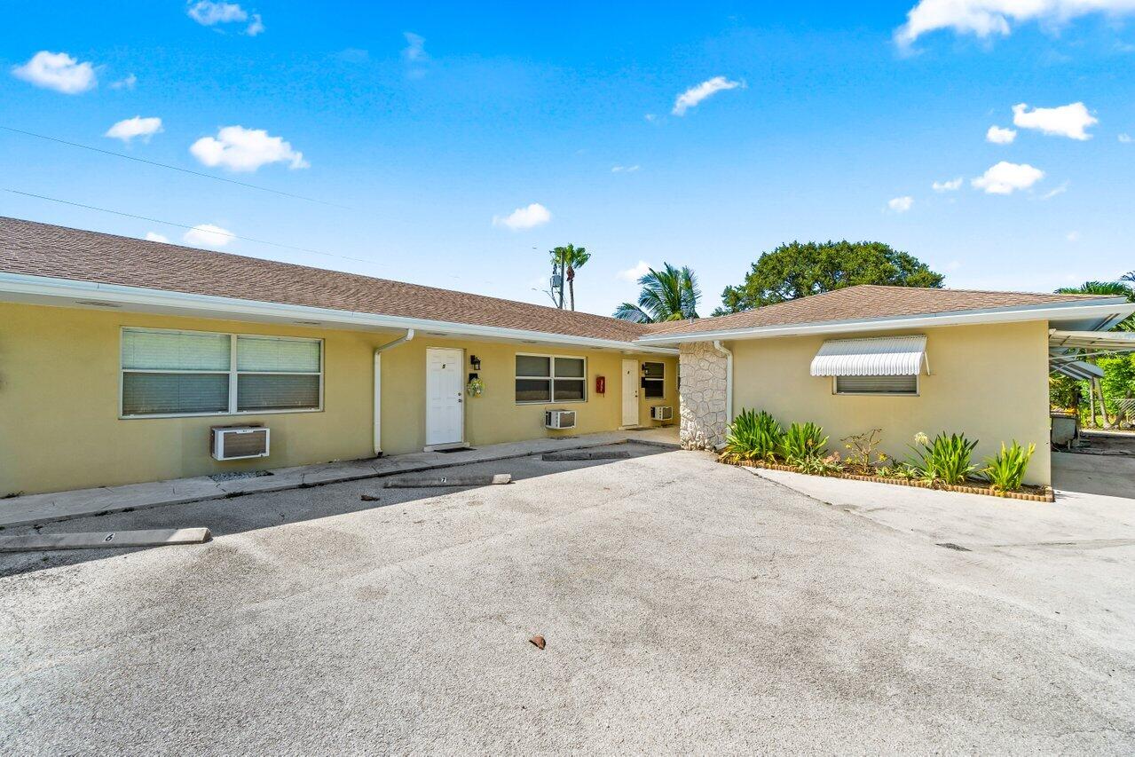 751 Hummingbird Way, Unit 7 North Palm Beach, FL 33408 - Photo 36 of 39 a view of a house with a yard and potted plants