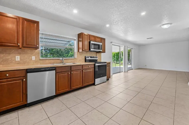 a kitchen with stainless steel appliances granite countertop a sink and cabinets