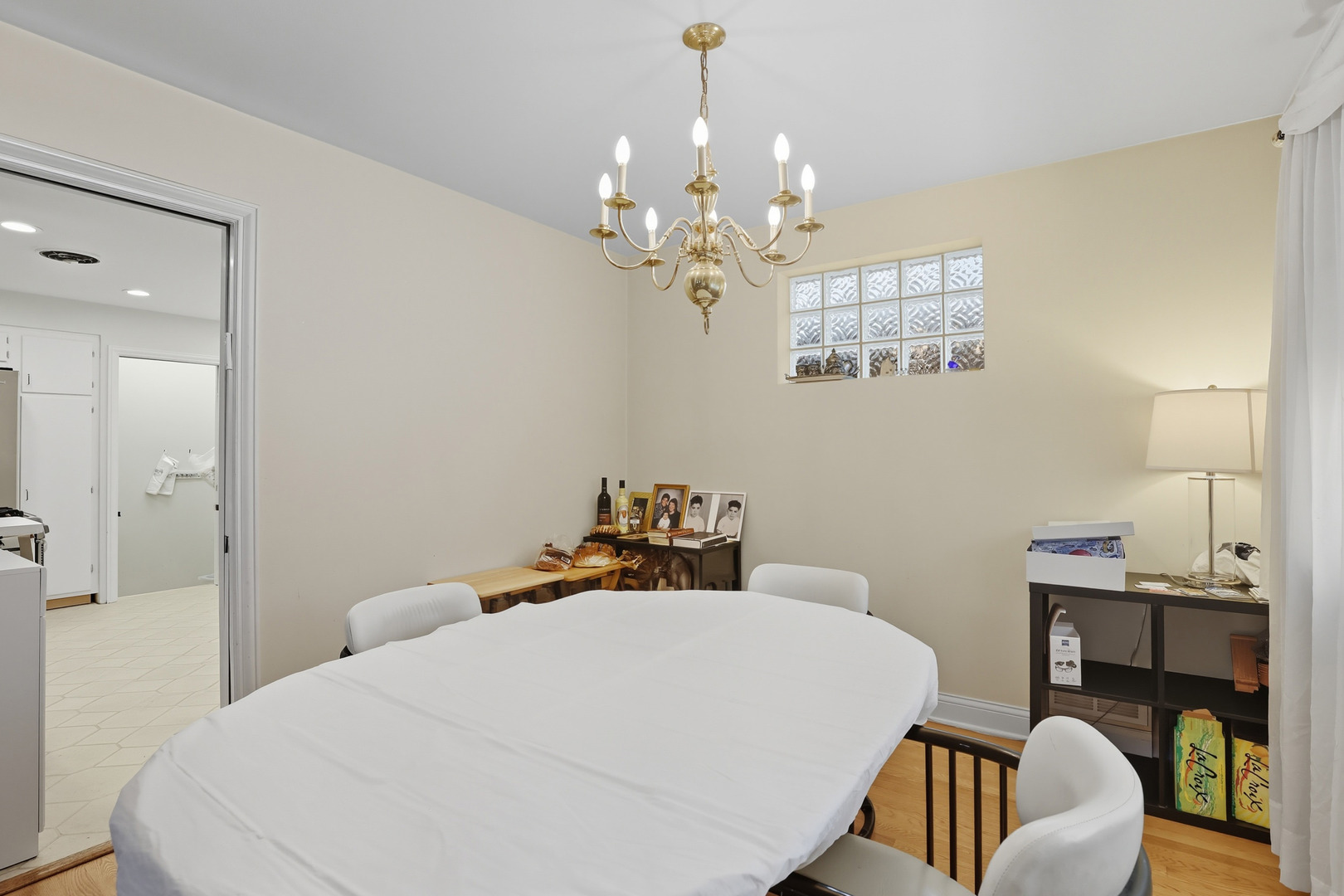 8728 Trumbull Avenue Skokie, IL 60076 - Photo 6 of 18 a bedroom with a bed a chandelier and a mirror