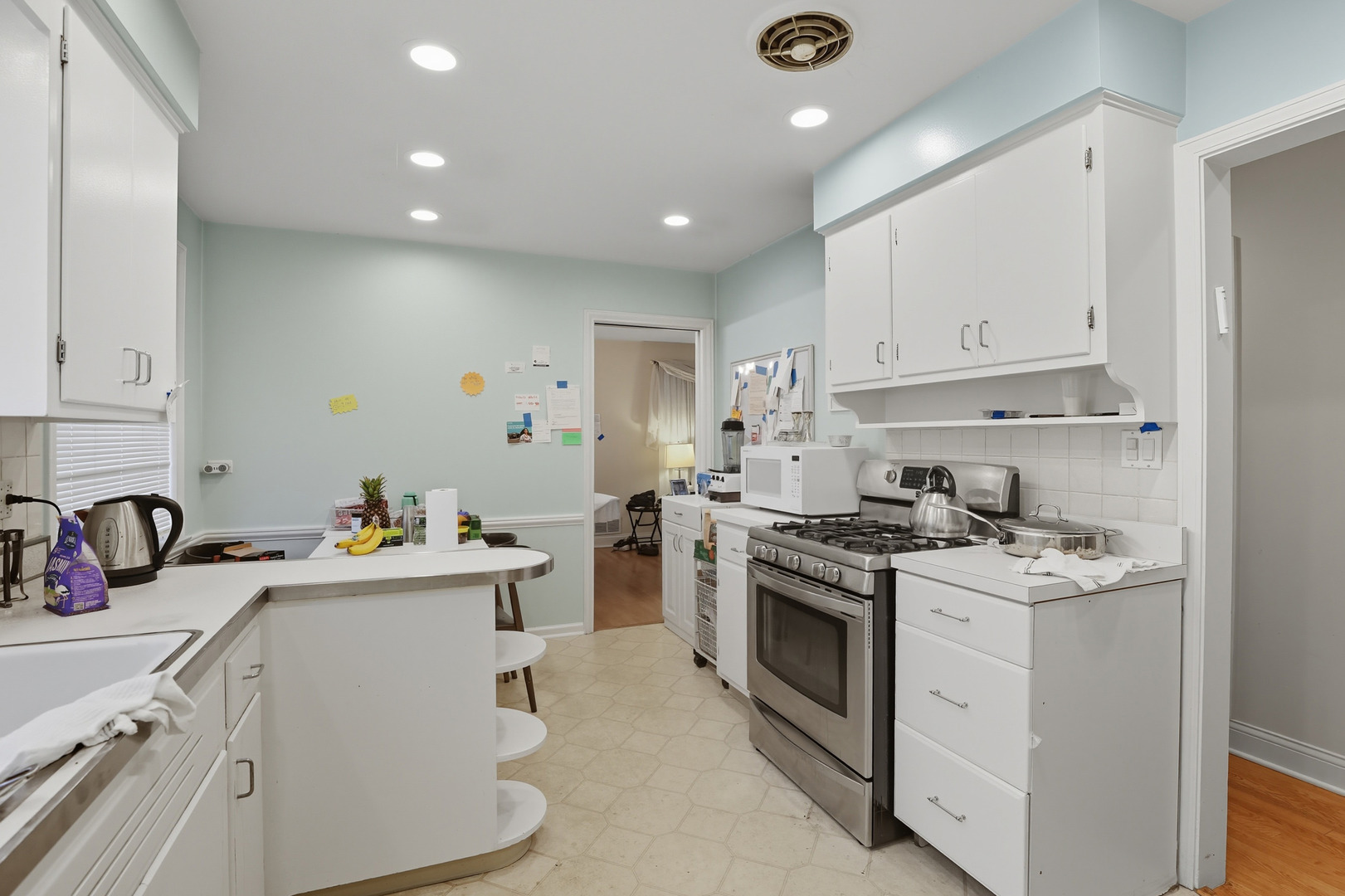 8728 Trumbull Avenue Skokie, IL 60076 - Photo 7 of 18 a kitchen that has a lot of cabinets in it and wooden floors