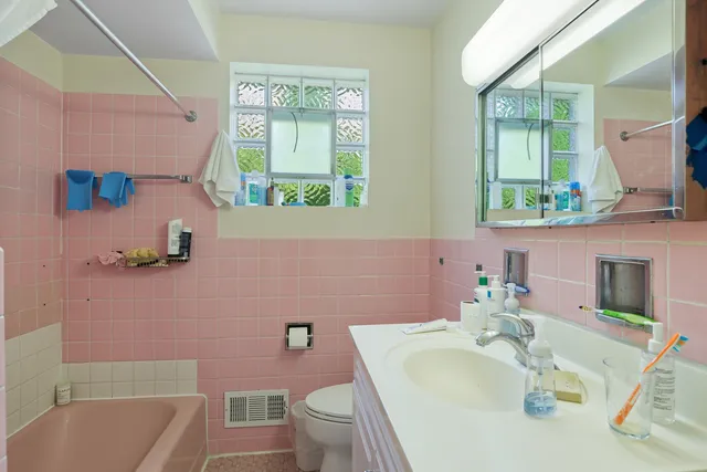 a bathroom with a sink mirror toilet and bathtub