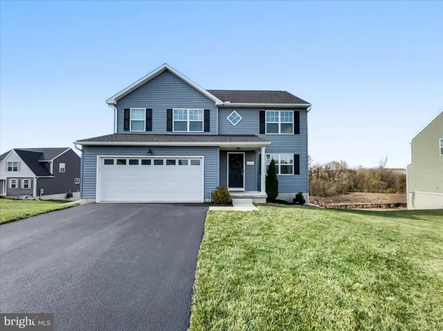 a view of a house with a yard and garage