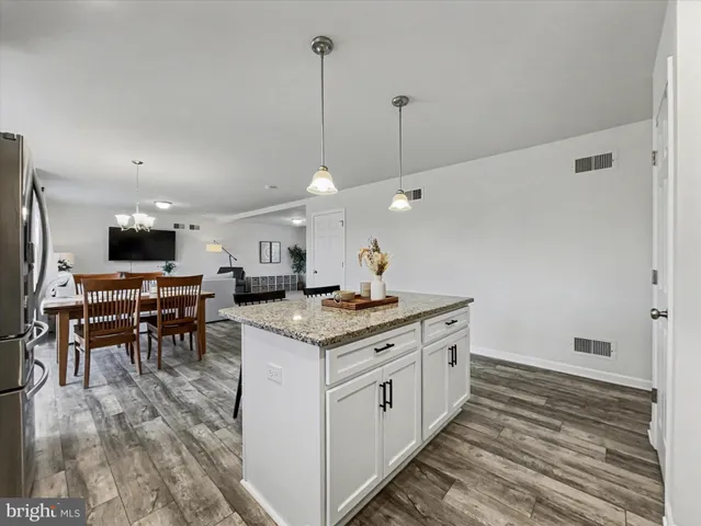 a kitchen with stainless steel appliances granite countertop a stove and a sink