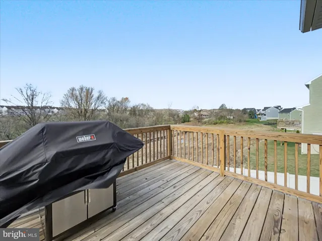 a balcony with wooden floor and city view