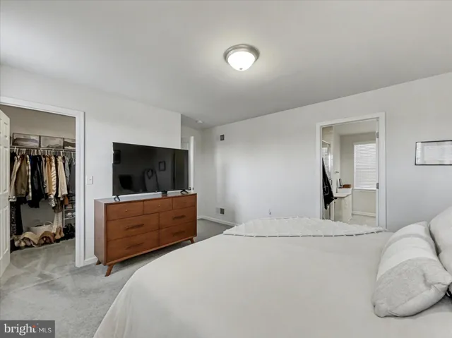 a bedroom with a bed and flat screen tv