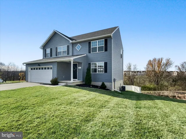 a view of a house with a yard and garage