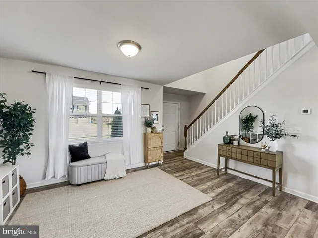 a view of entryway and hall with wooden floor