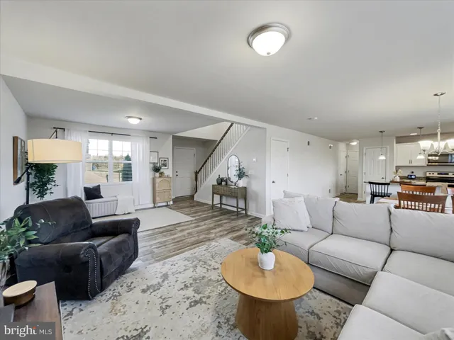 a living room with furniture and a view of kitchen