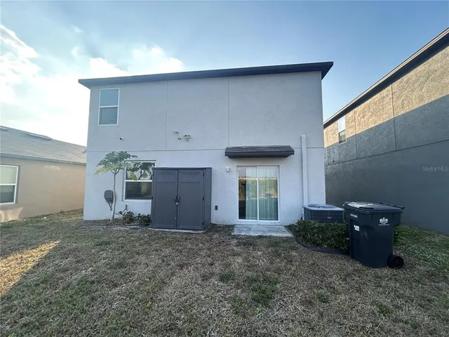 a view of a house with a yard and garage