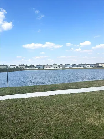 a view of a lake with houses in the background