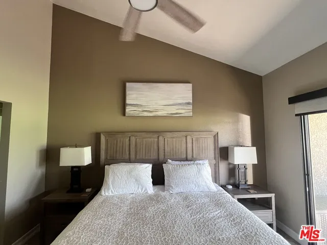 a bedroom with a bed and a lamp on table