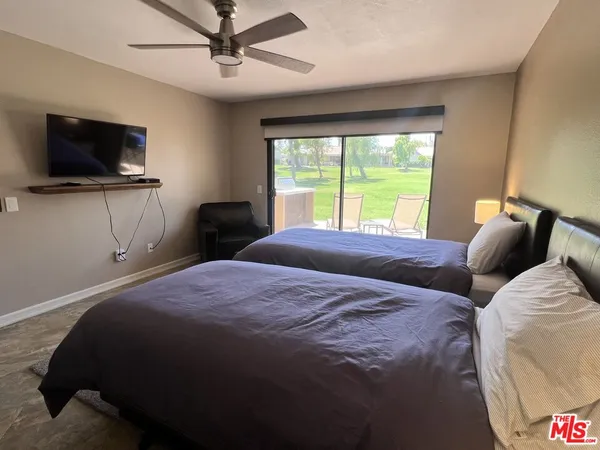 a bedroom with a bed and a flat screen tv