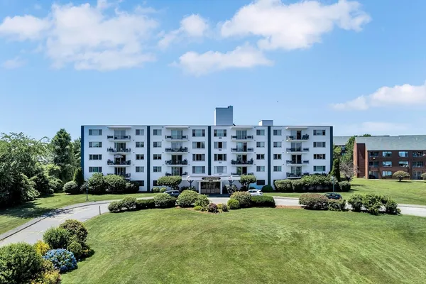 a view of a building and yard with green space