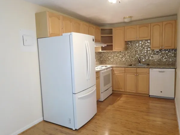 a white refrigerator freezer sitting inside of a kitchen