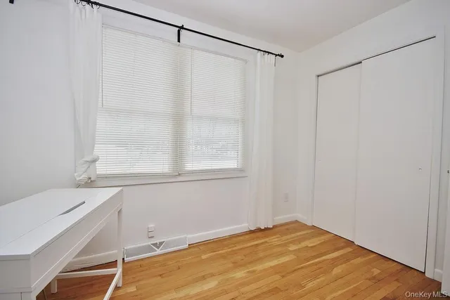 a view of a room with wooden floor and windows