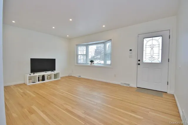 a room with a bed and a flat screen tv