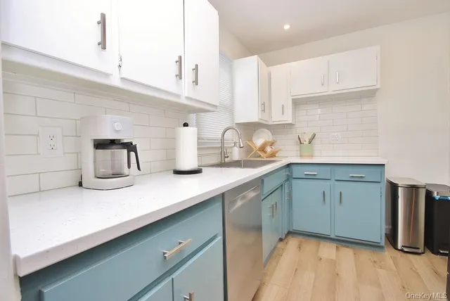 a kitchen with cabinets a sink and appliances