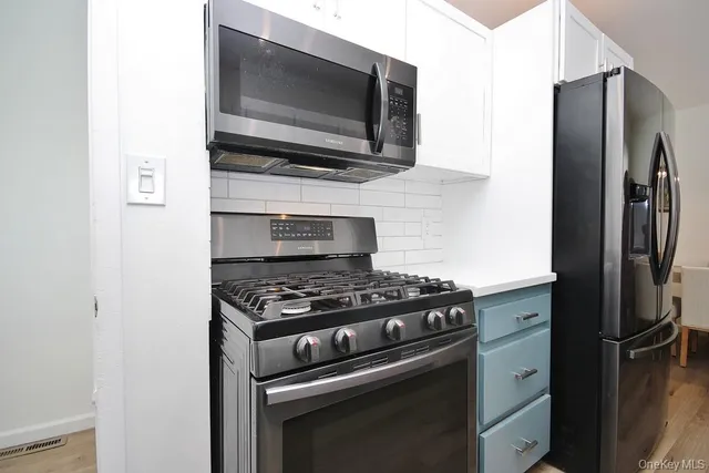 a kitchen with a stove and a microwave
