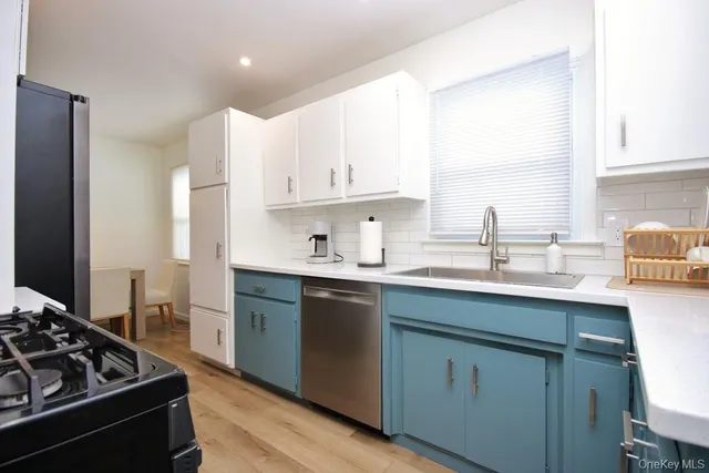 a kitchen with a sink stove and cabinets