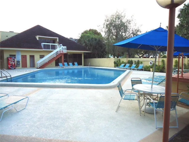 a view of a chairs and table in the patio